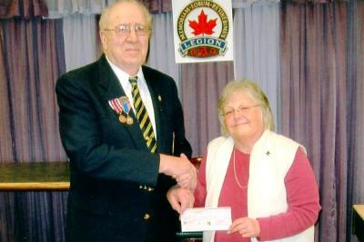 Royal Canadian Legion, Branch # 141, Jim Rickerby presents a cheque for $500. to Jean Lindgren of South Peace Senior Access Services Society.
Dawson Creek, B.C., 
2012  